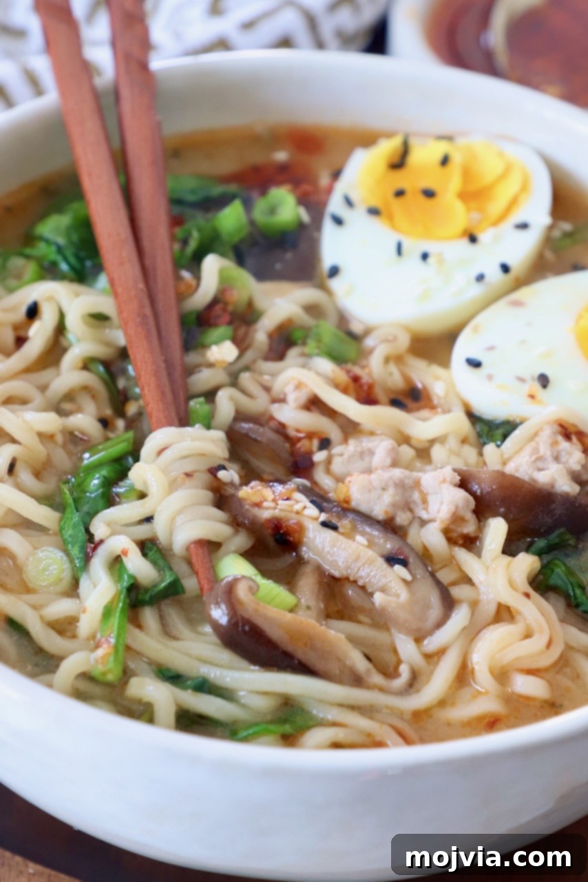 Golden Miso Noodle Perfection 10 A beautifully presented bowl of Miso Ramen, garnished with soft-boiled eggs, green onions, and other toppings, with chopsticks poised for eating.