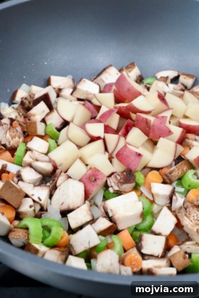 Rustic Vegetable Pot Pie 8 Diced potatoes mixed with the other simmering vegetables in the pan