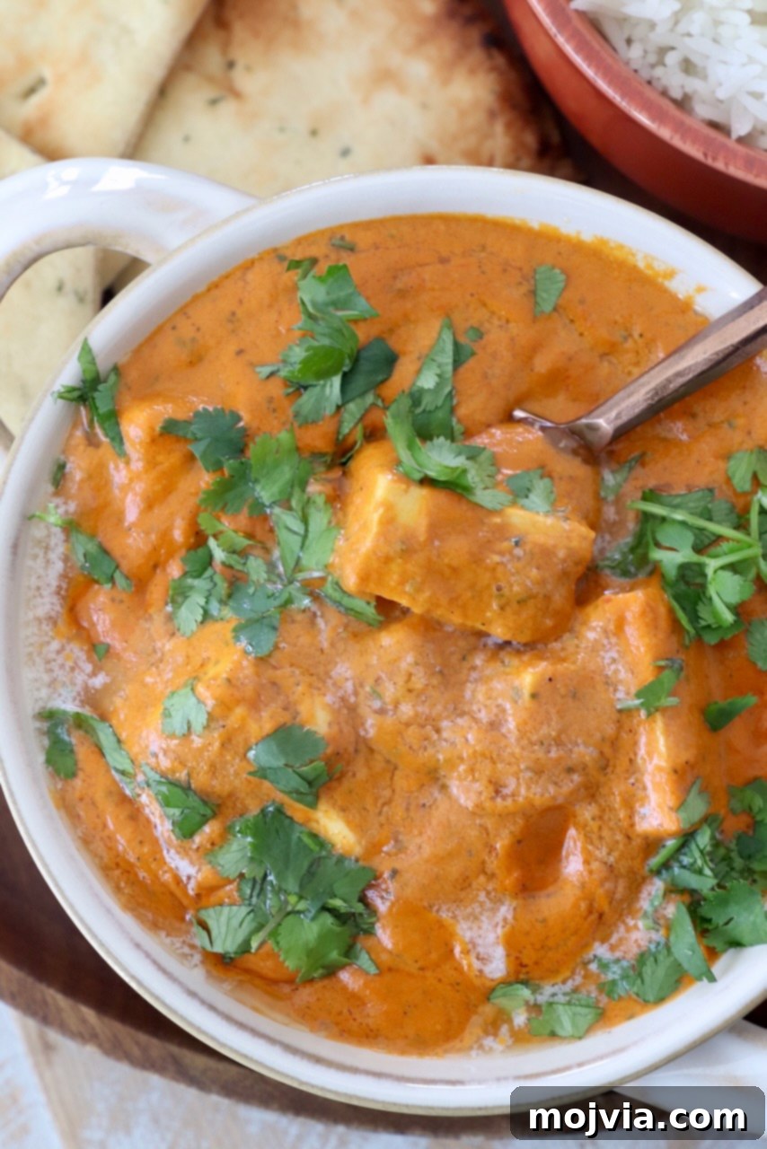 Buttery Paneer Indulgence 2 prepared paneer makhani in bowl with spoon