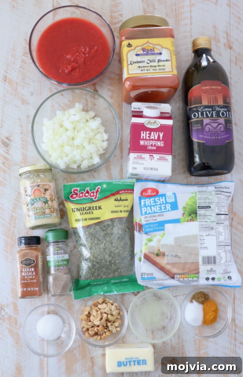 Buttery Paneer Indulgence 3 ingredients for paneer makhani on white wood board