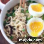 Plant-Based Ramen Perfection 8 Cooked ramen noodles in a bowl with chopsticks and a soft-boiled egg.