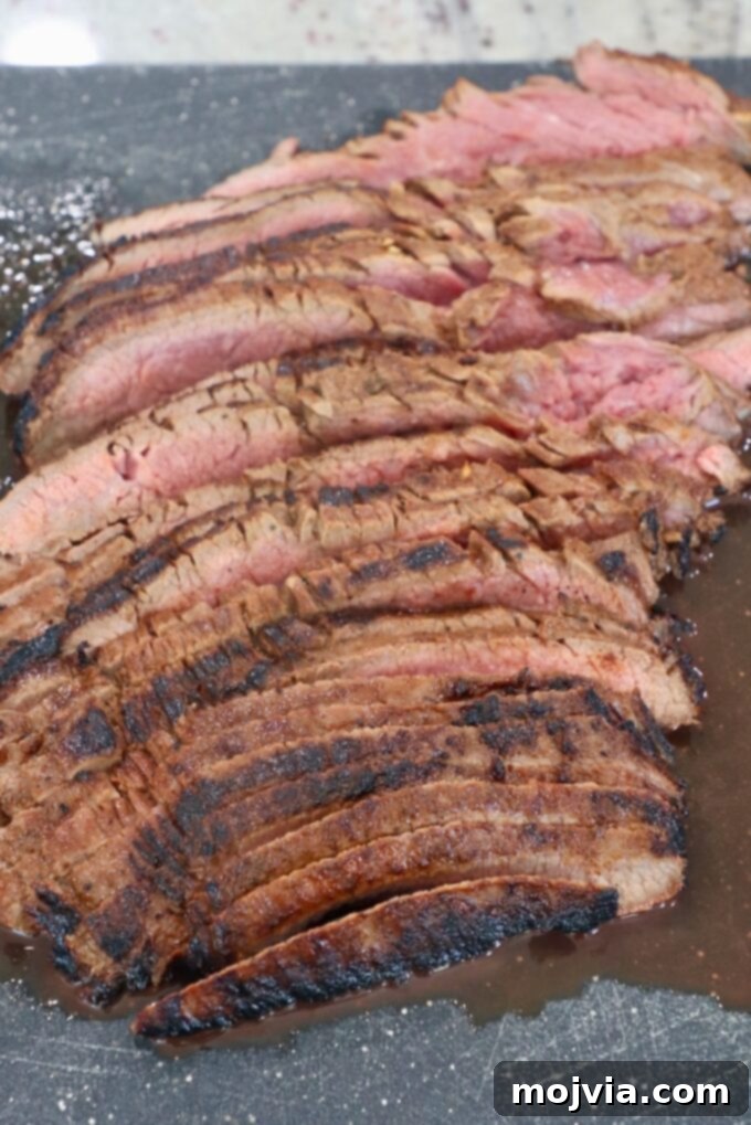 Sizzling Flank Steak Tacos 10 thinly sliced grilled steak on cutting board