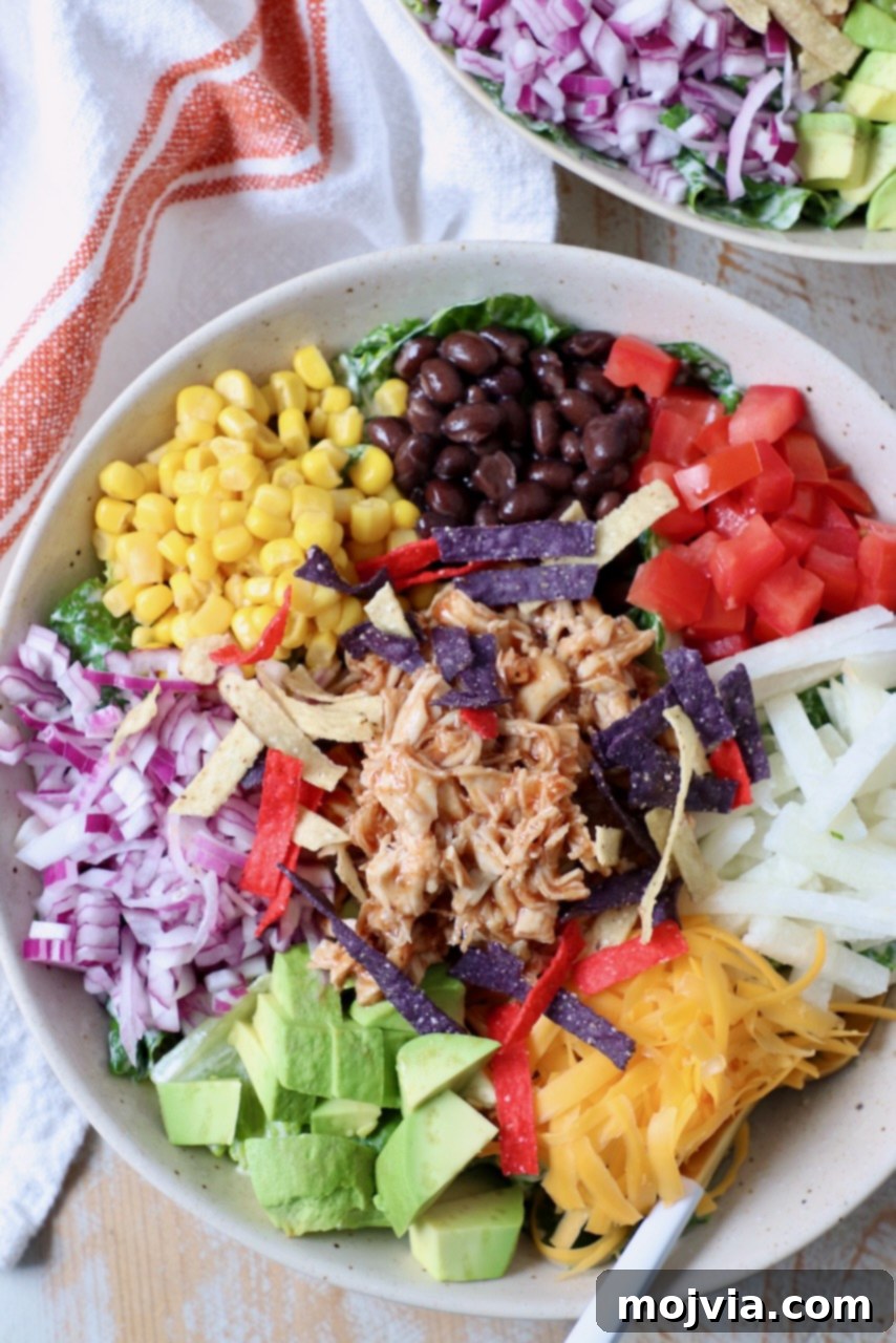Close-up of a single bowl of BBQ Chicken Salad with a fork