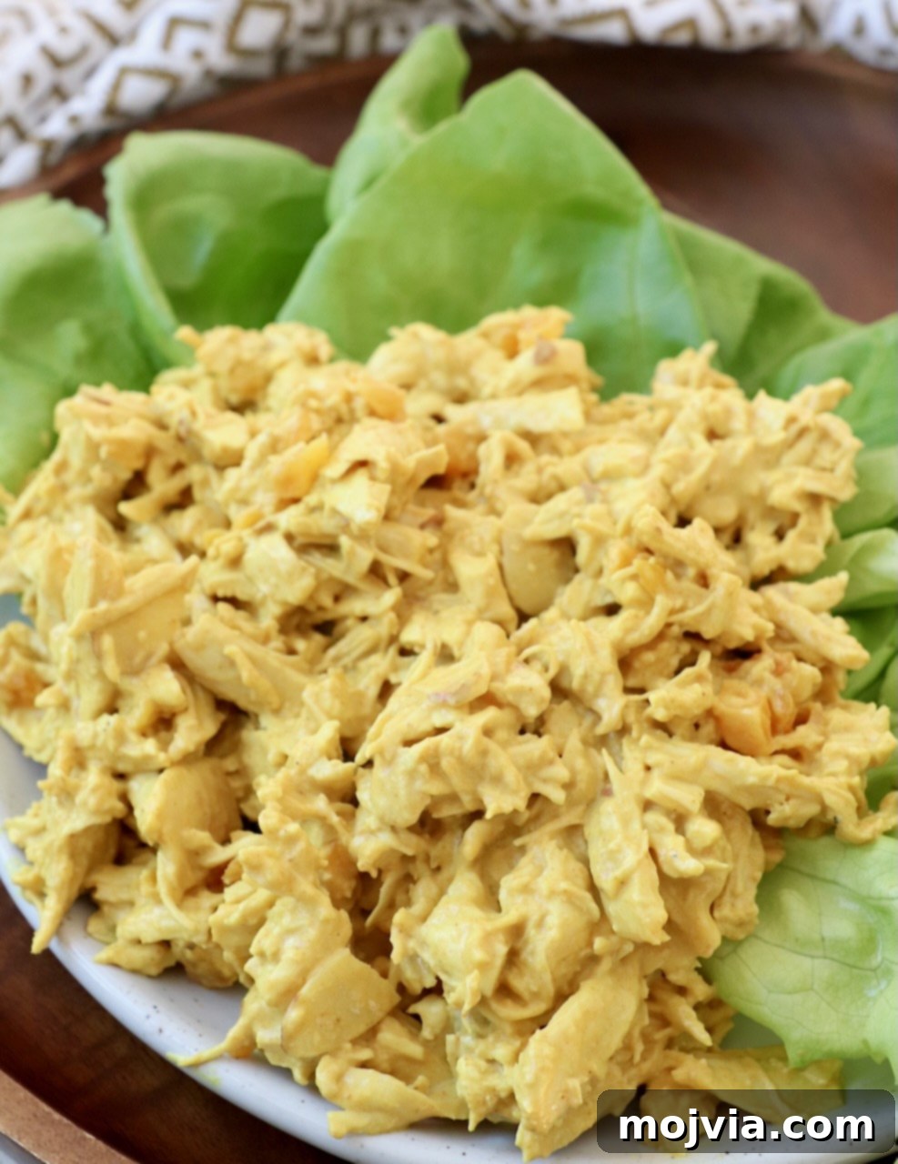 Crown Jewel Chicken Salad 2 curry chicken salad on top of lettuce leaves on plate