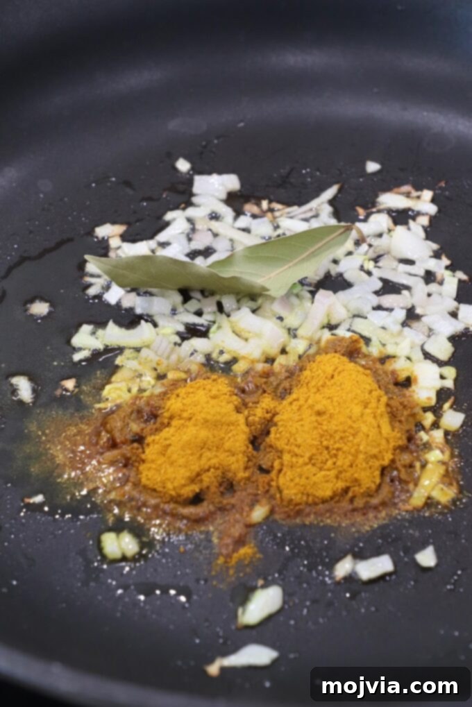 Crown Jewel Chicken Salad 4 curry powder, diced shallots and bay leaf in a skillet