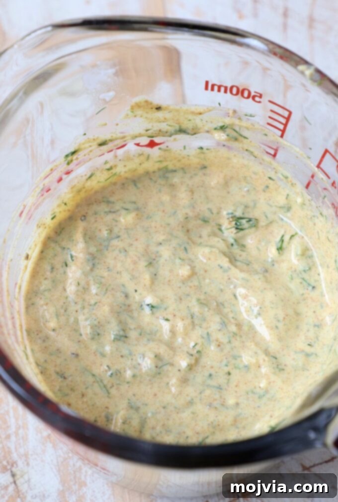 Refreshing Greek Yogurt Pasta Salad 4 Close-up of creamy curry dill Greek yogurt salad dressing in a glass bowl
