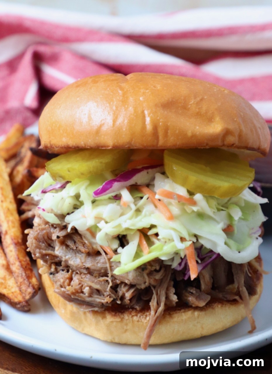Quick and Tender Pressure Cooker Pork 2 pulled pork sandwich on plate with french fries