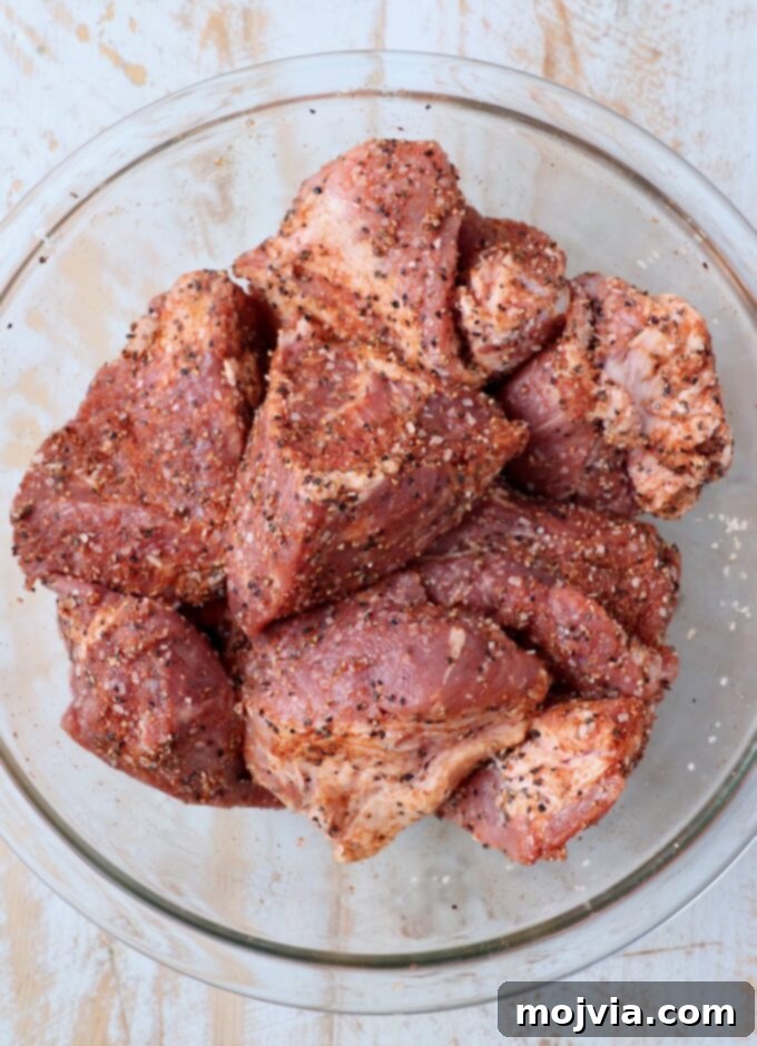 Quick and Tender Pressure Cooker Pork 4 large pieces of pork shoulder seasoned in large glass bowl