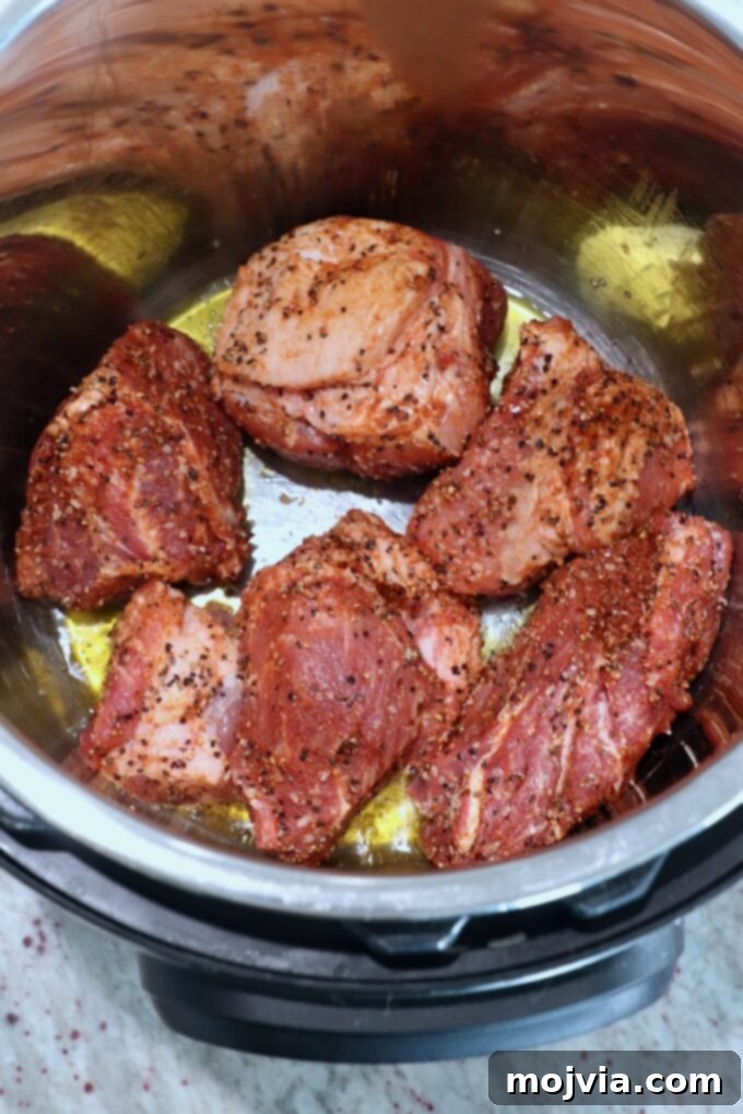 Quick and Tender Pressure Cooker Pork 5 large pieces of seasoned pork in olive oil in Instant Pot