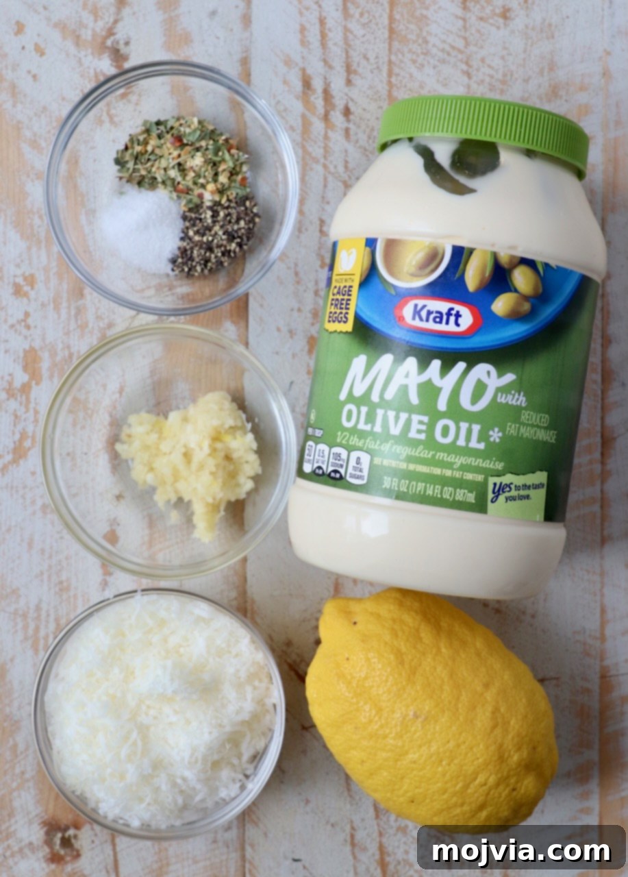 Creamy Garlic Parmesan Indulgence 3 Ingredients for homemade garlic parmesan sauce laid out on a white wooden board