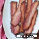 cooked slices of bacon on white plate