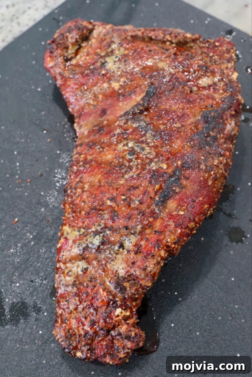 smoked, seared tri tip roast on cutting board