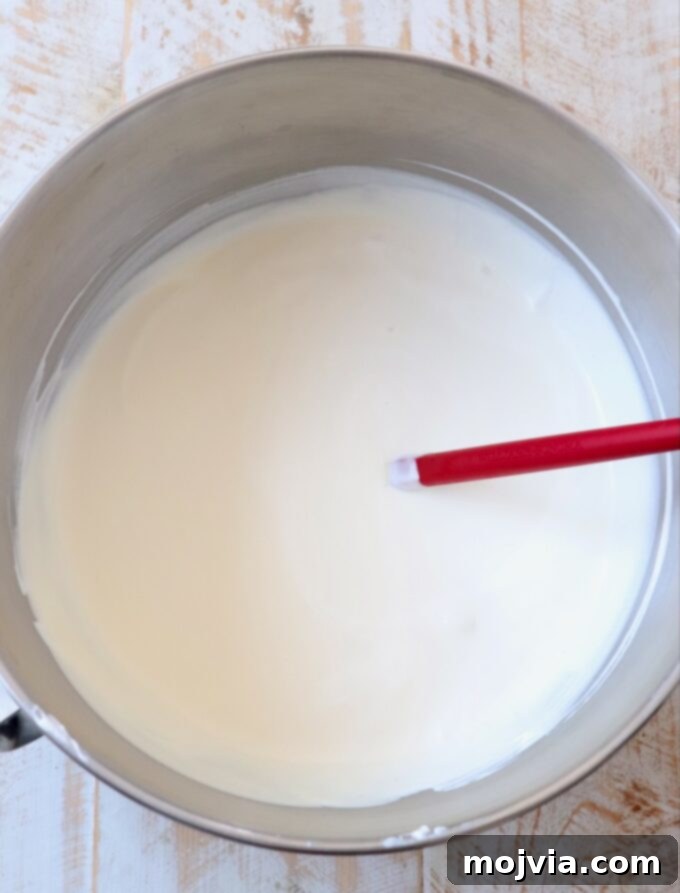 Maple Bacon No-Churn Ice Cream 6 Freshly whipped heavy cream with firm peaks in a large mixing bowl.