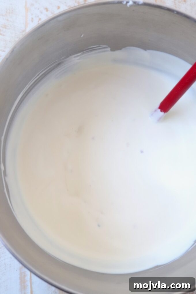 Maple Bacon No-Churn Ice Cream 8 The fully combined maple bacon ice cream base in a mixing bowl, ready for freezing.