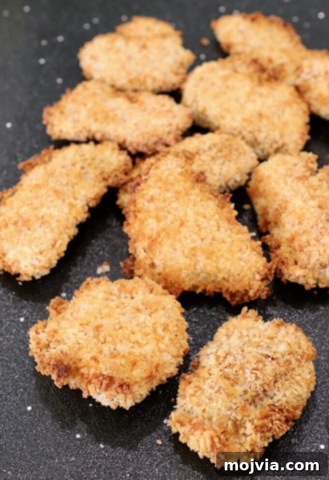 Crispy Boneless Bites 11 crispy pieces of cooked chicken on cutting board