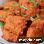 boneless chicken wings tossed in buffalo sauce on plate