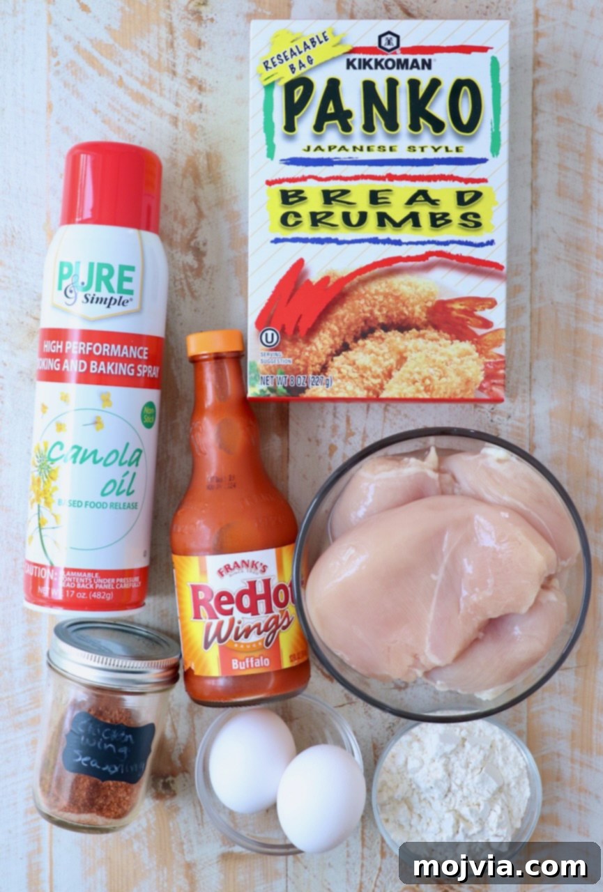 Crispy Boneless Bites 3 ingredients for boneless wings on white wood board