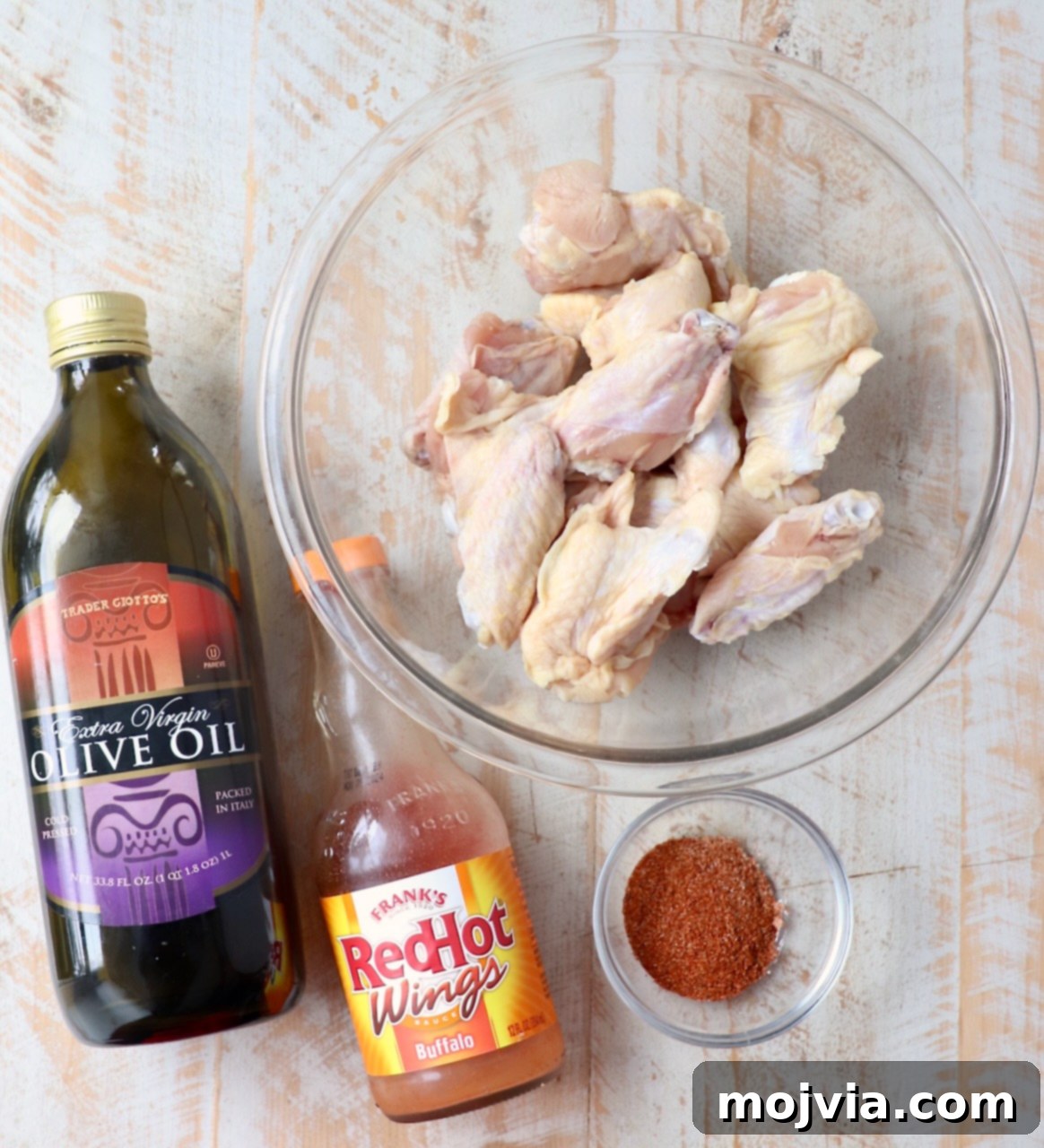 Ultimate Smoked Chicken Wings 3 ingredients for grilled chicken wings on white wood board