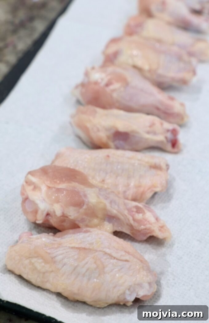Ultimate Smoked Chicken Wings 4 raw chicken wings on paper towels