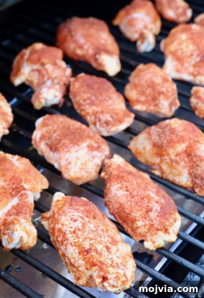 Ultimate Smoked Chicken Wings 6 seasoned raw chicken wings on smoker
