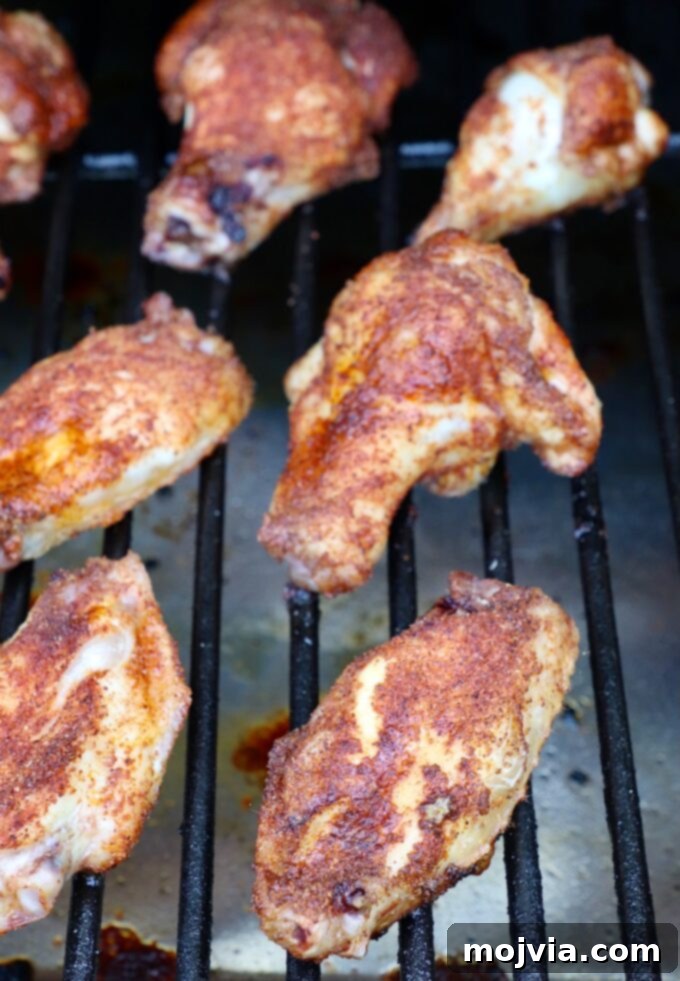 Ultimate Smoked Chicken Wings 7 cooked, seasoned chicken wings on smoker