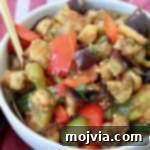 eggplant salad in bowl with spoon