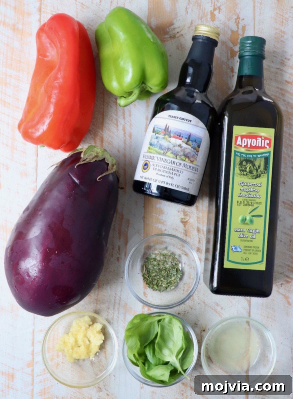 Smoky Eggplant Salad 3 ingredients for eggplant salad on white wood board