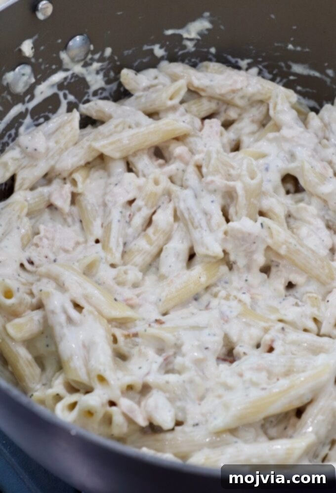 finished garlic parmesan chicken pasta in a large pan, ready to serve