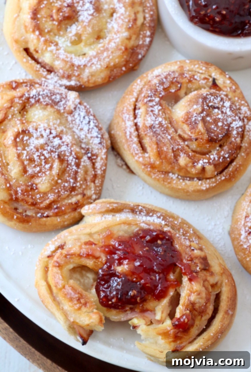 monte cristo rolls topped with raspberry jam on a plate
