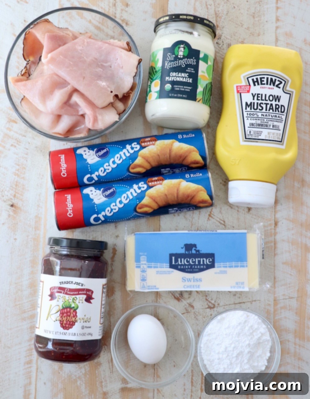 ingredients for monte cristo rolls on white wood board