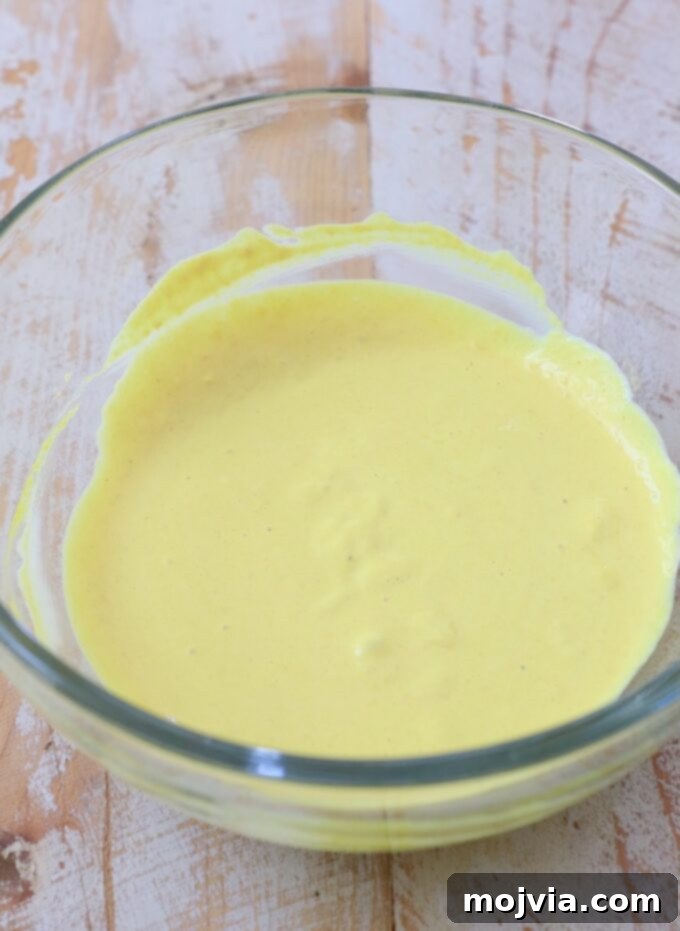 mayonnaise and mustard combined in a small glass bowl