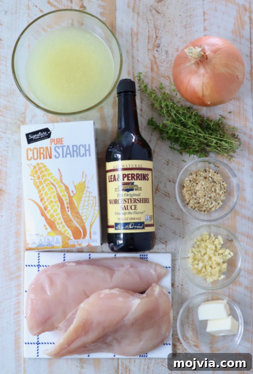 Rich Slow Cooker French Onion Chicken 3 Ingredients for French Onion Chicken laid out on a white wooden board.
