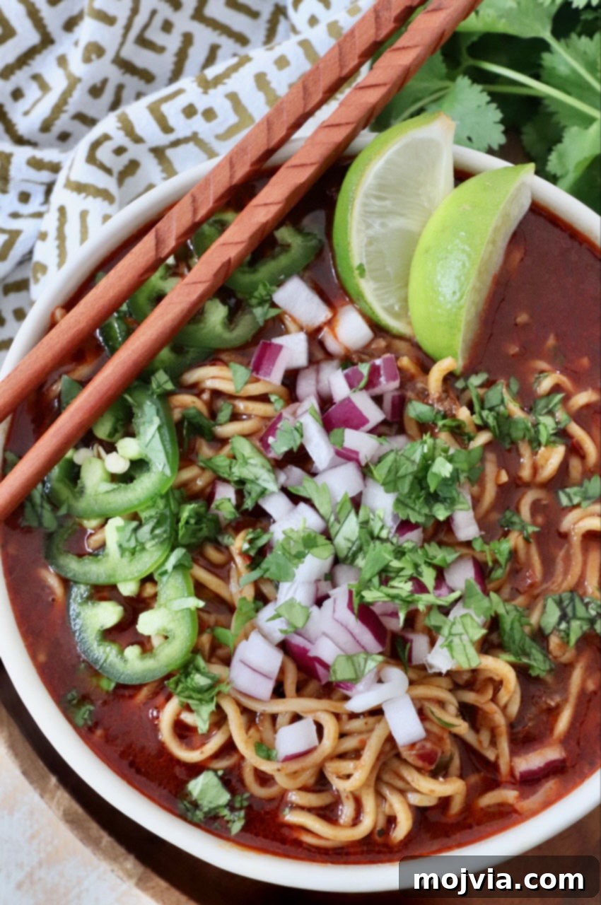 birria ramen in bowl with chopsticks on the side
