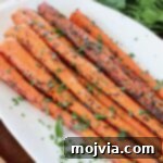 roasted carrots on plate topped with fresh chopped parsley