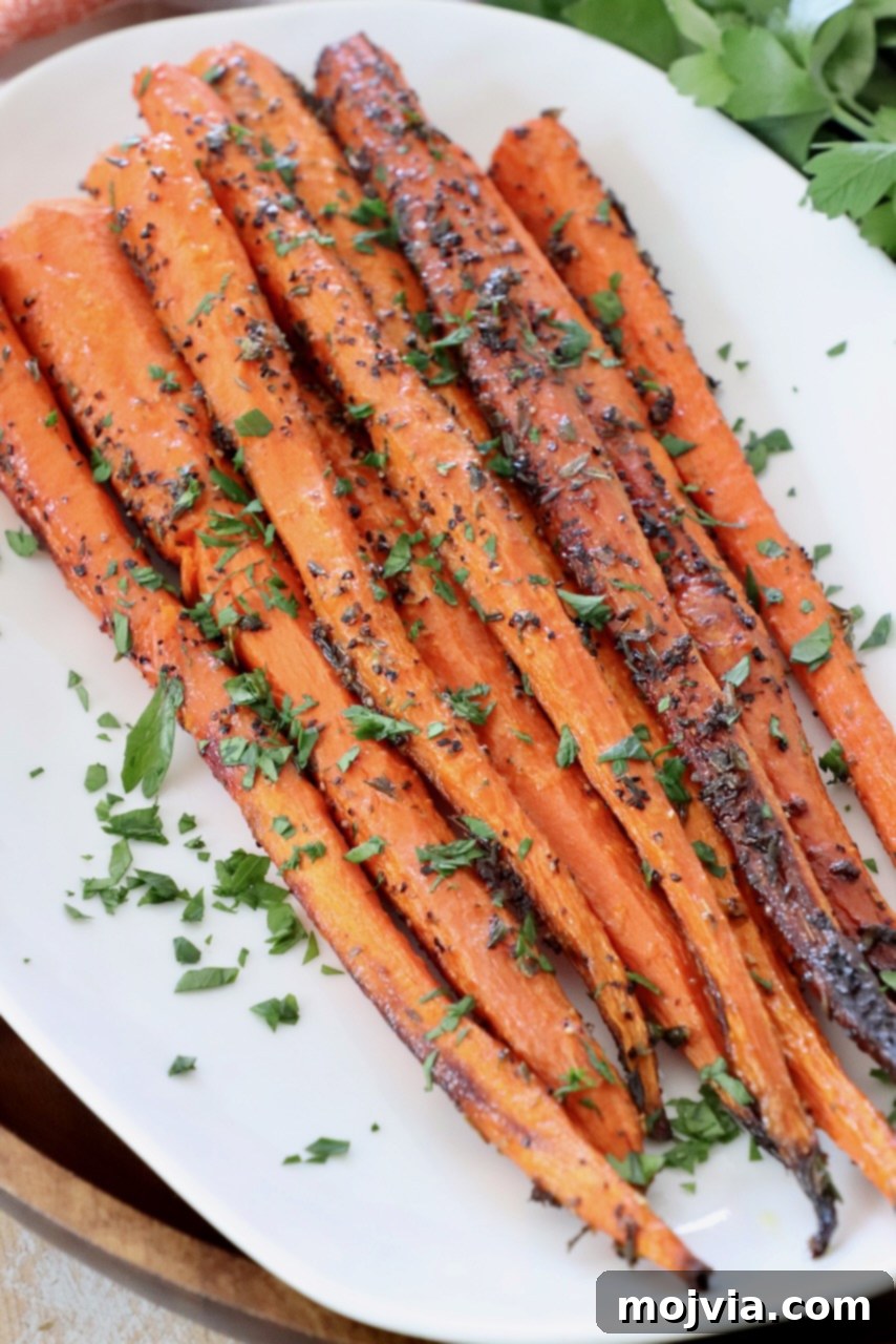 oven roasted carrots on a white plate, ready to be served