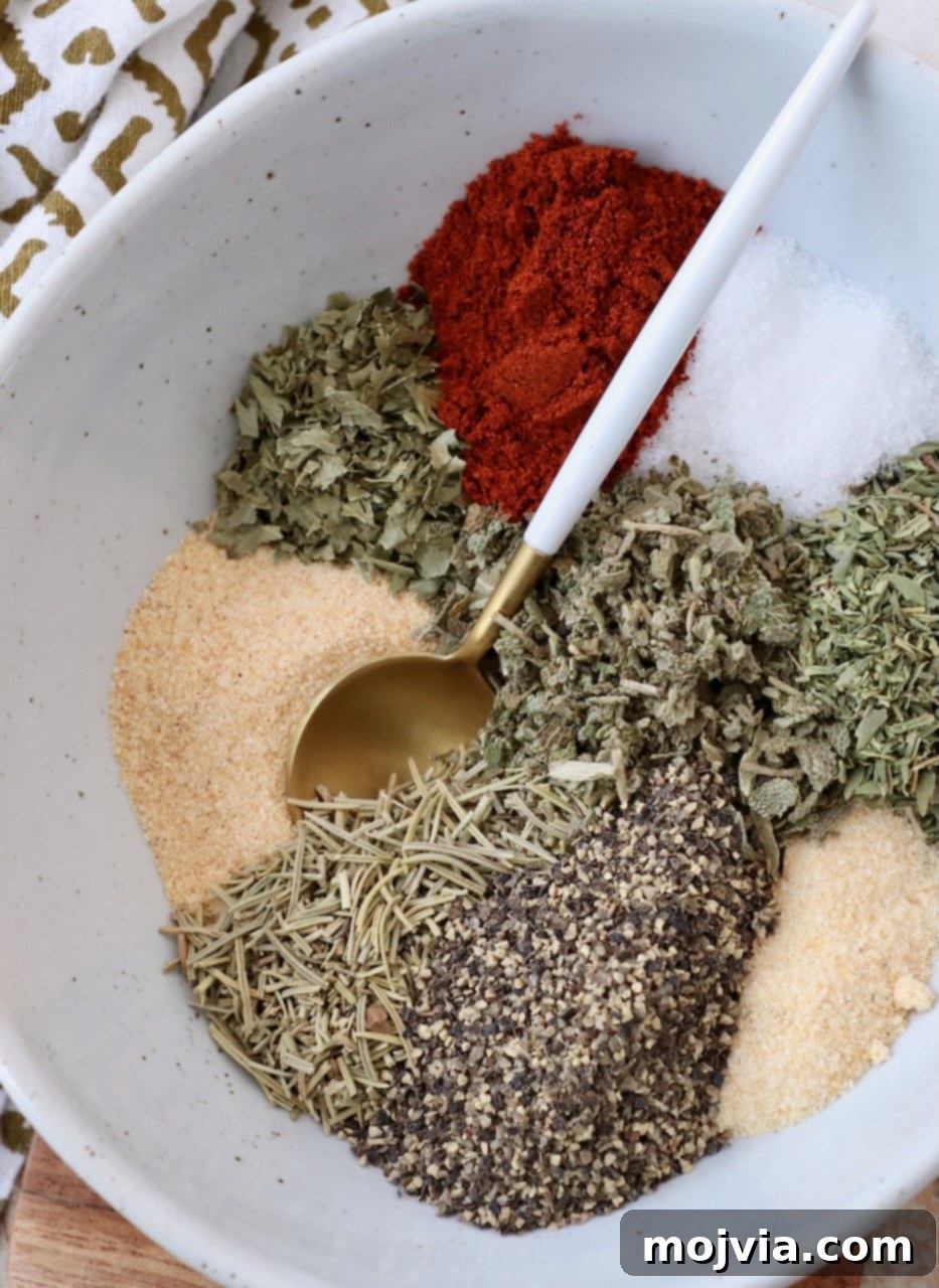 Assortment of vibrant herbs and spices separated in bowls, ready to be blended for the perfect turkey seasoning.