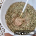 Turkey seasoning in bowl with spoon, ready to be used for cooking.