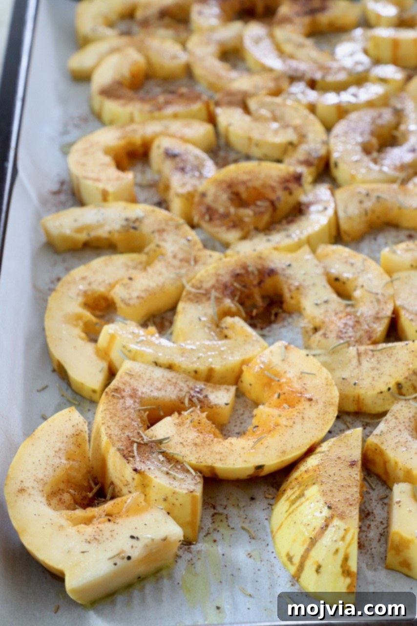 Roasted Delicata Harvest Bowl 4 sliced seasoned delicata squash on baking sheet