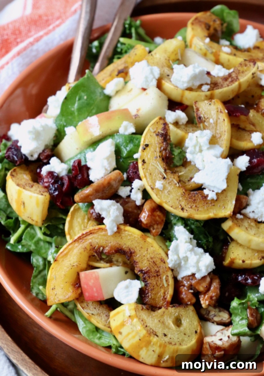 Roasted Delicata Harvest Bowl 6 roasted sliced delicata squash on top of salad in bowl