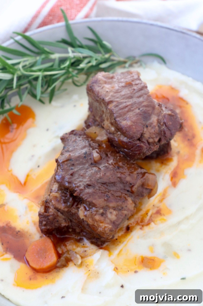 Melt-Off-The-Bone Guinness Short Ribs 12 braised short ribs on top of mashed potatoes in bowl