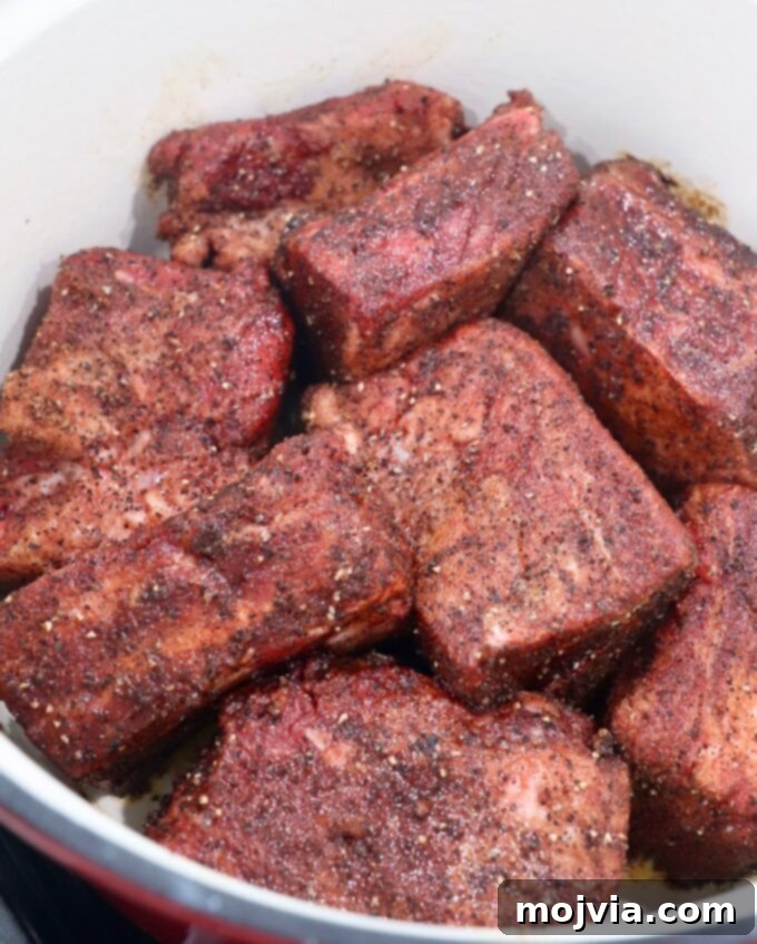 Melt-Off-The-Bone Guinness Short Ribs 5 seasoned short ribs in dutch oven on stove