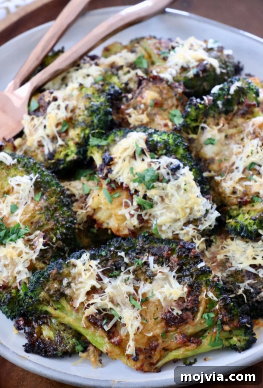 Crispy Smashed Broccoli 2 Smashed broccoli on a plate with forks, showcasing its crispy texture and golden-brown edges