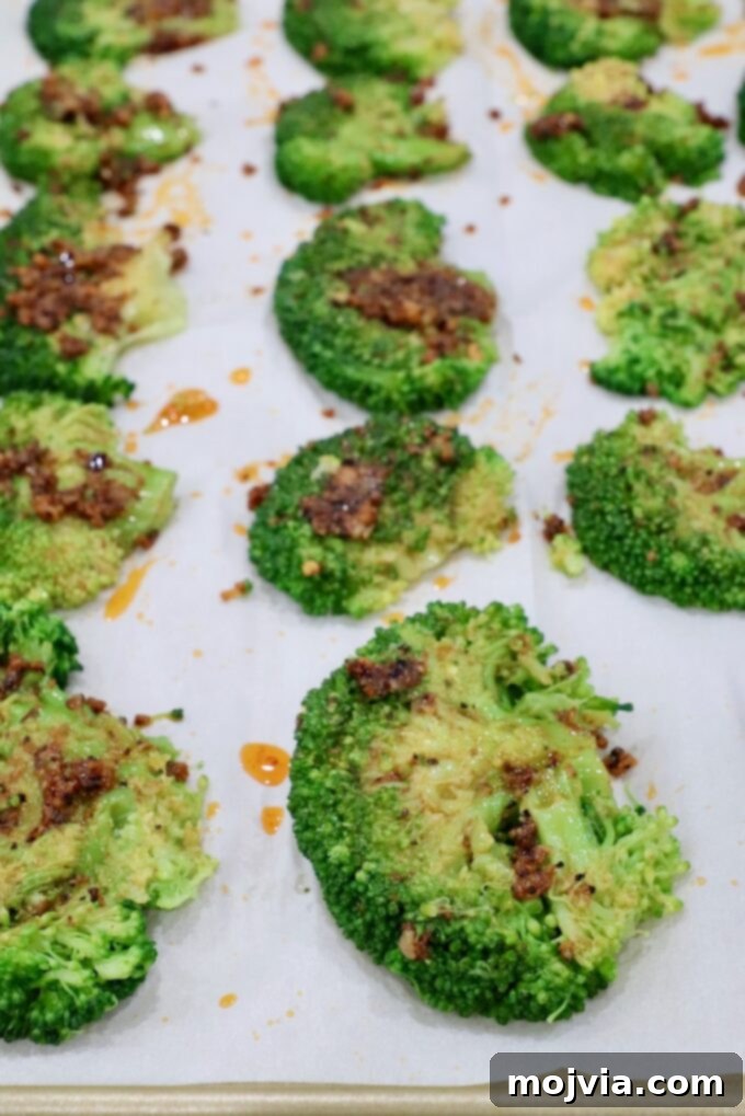 Crispy Smashed Broccoli 8 Smashed broccoli florets arranged in a single layer on a baking sheet, brushed with the lemon-garlic butter