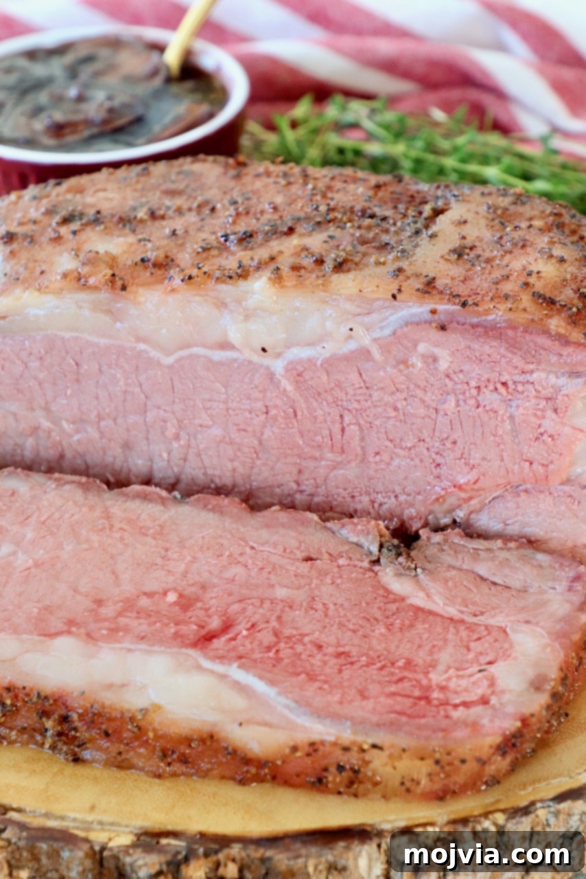 Slow Smoked New York Strip Roast 2 smoked new york strip roast sliced on wood board