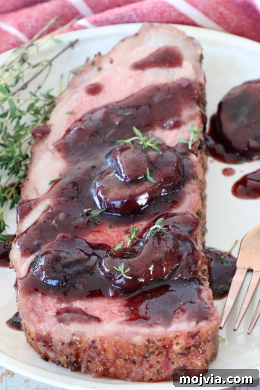 Slow Smoked New York Strip Roast 13 smoked new york strip steak on plate, covered in red wine sauce