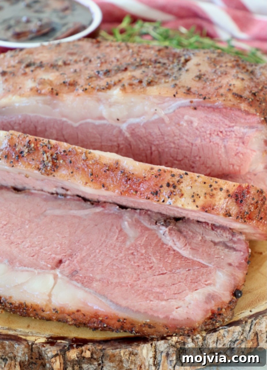 Slow Smoked New York Strip Roast 15 sliced, smoked new york strip roast on wood board