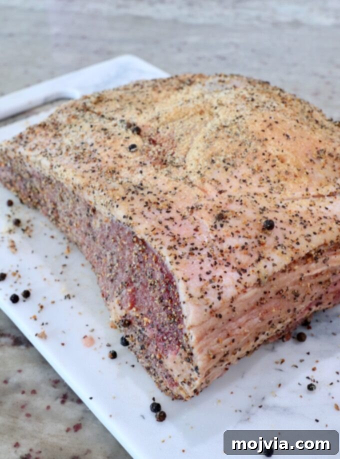 Slow Smoked New York Strip Roast 4 seasoned strip roast on cutting board
