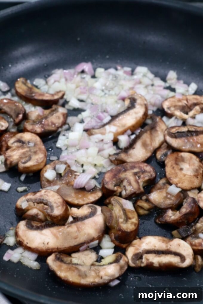 Slow Smoked New York Strip Roast 9 sliced mushrooms and diced shallots in a skillet