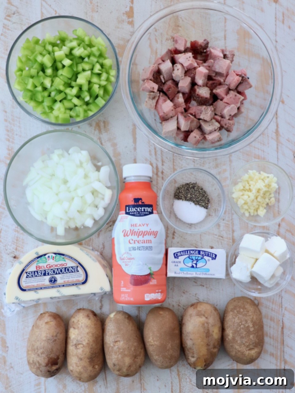 Philly Cheesesteak Skillet 3 ingredients for cheesesteak hash on white wood board