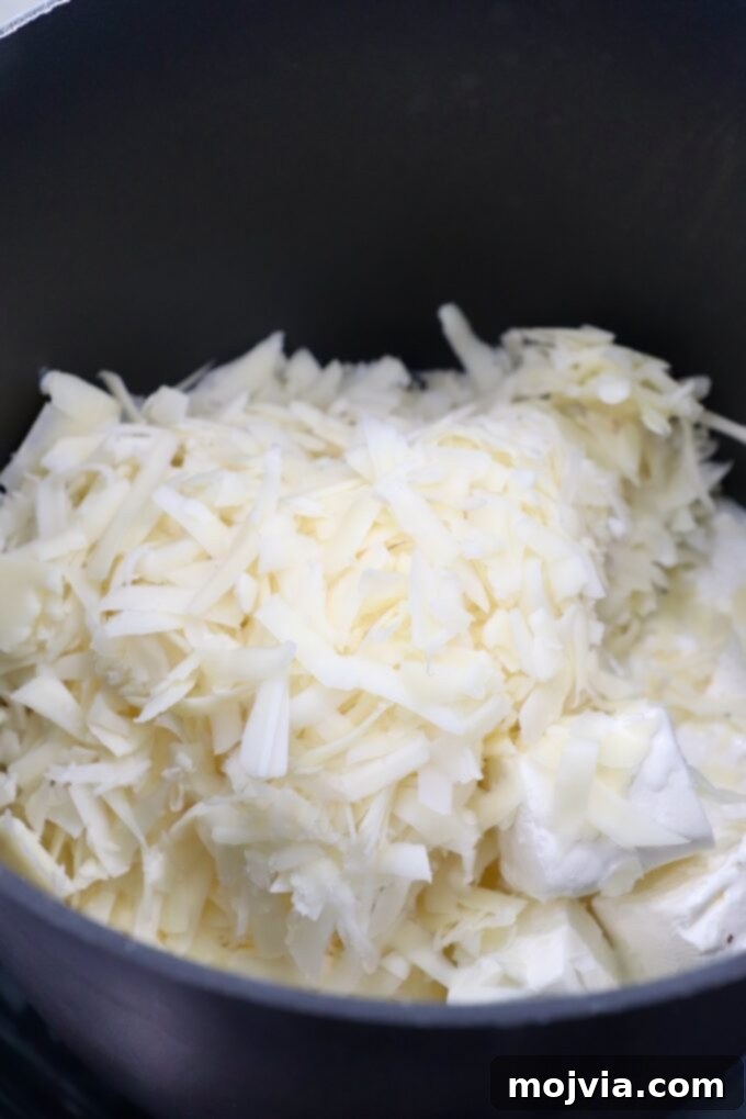 Philly Cheesesteak Skillet 7 shredded provolone and cubed cream cheese in pot